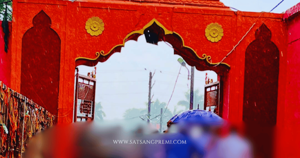 Devotees in a queue, holding offering baskets with coconut, flowers, and a bottle of liquor